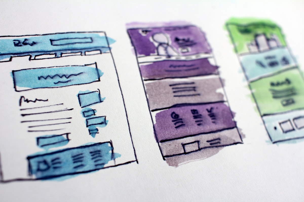 Hand-drawn watercolour wireframe sketches of website layouts